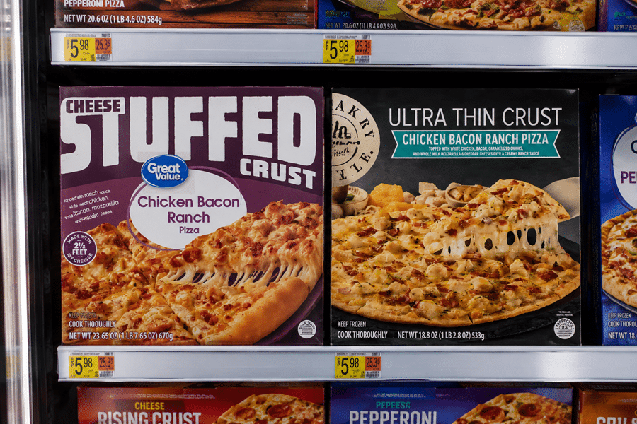 Frozen pizzas on a store shelf: Cheese Stuffed Crust Chicken Bacon Ranch and Ultra Thin Crust Chicken Bacon Ranch boxes side by side